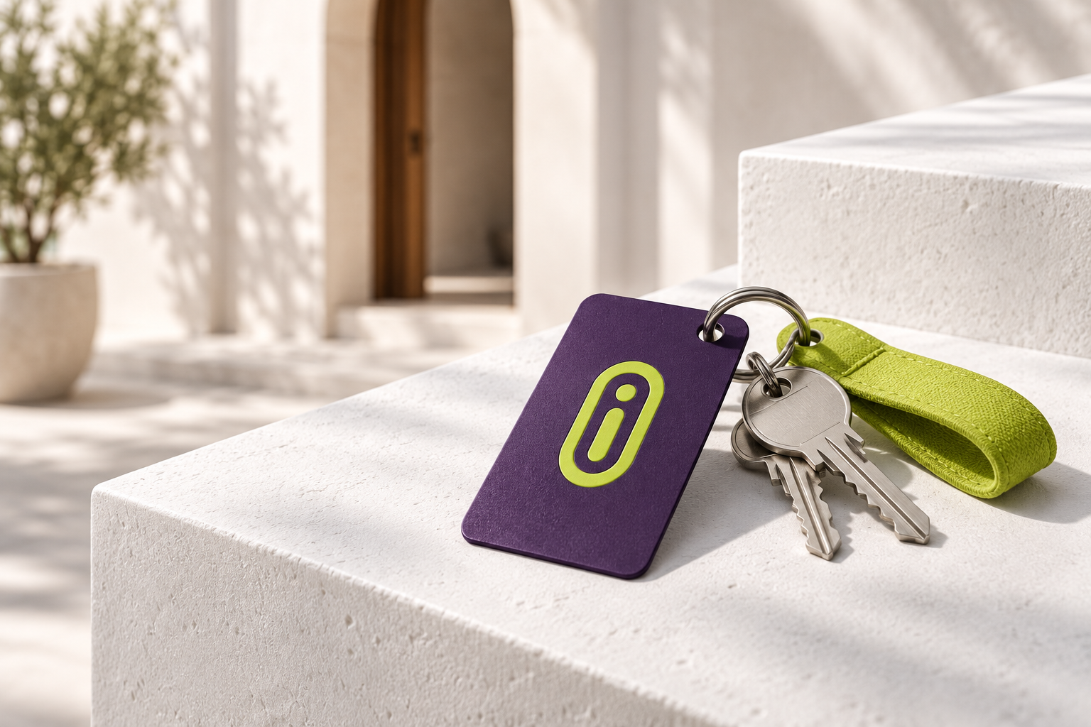 Purple Ghurfa key tag and lime strap on a sunlit stone surface